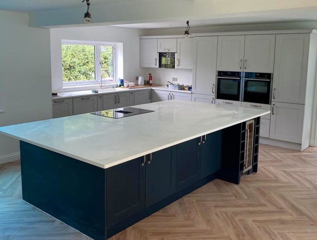 Two tone shaker kitchen Hertfordshire - Mussel and blue shaker style kitchen with quartz island worktop